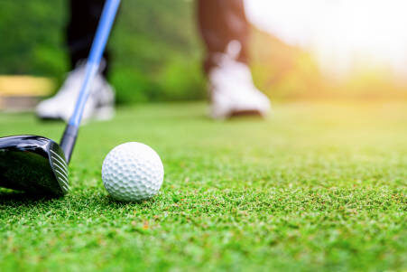 Close up golf ball on green grass field. sport golf club